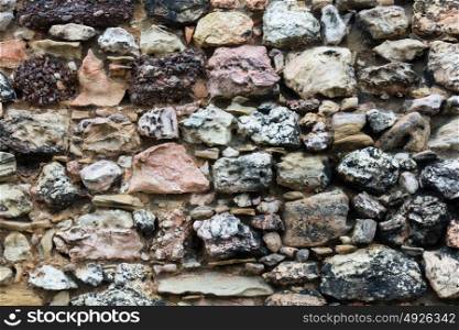 Stony wall from big cobblestones close up, background.