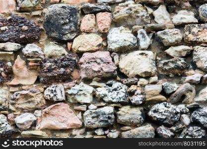 Stony wall from big cobblestones close up, background.