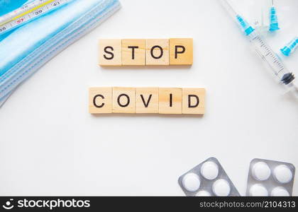 Stop coronavirus inscription. Preparation for vaccination against covid-19. Syringe, vaccine, pills, medical mask. Stop coronavirus inscription. Preparation for vaccination against covid-19. Syringe, vaccine, pills, medical mask.