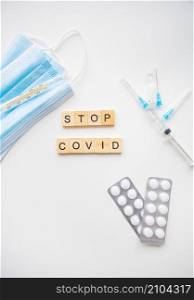 Stop coronavirus inscription. Preparation for vaccination against covid-19. Syringe, vaccine, pills, medical mask. Stop coronavirus inscription. Preparation for vaccination against covid-19. Syringe, vaccine, pills, medical mask.