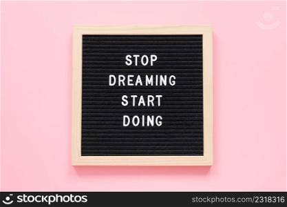 Stop Dreaming Start Doing. Motivational"e on≤tterboard onπnk background. Top view Flat lay Concept insπrational"e of the day.. Stop Dreaming Start Doing. Motivational"e on≤tterboard onπnk background. Top view Flat lay Concept insπrational"e of the day
