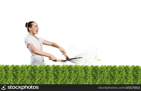 Stop pollution. Young attractive businesswoman cutting green lawn. Greenery concept