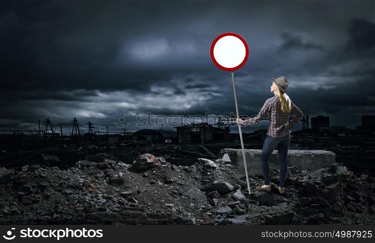 Stop pollution!. Young girl in casual holding stop sign