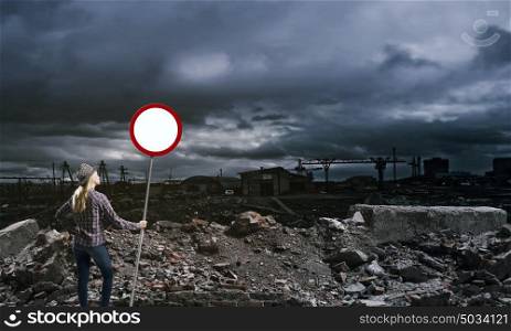 Stop pollution!. Young girl in casual holding stop sign