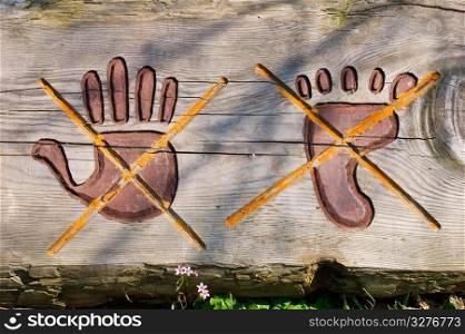 Stop sign engrave on wood. Do not touch by hand or foot