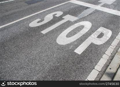 stop sign painted on a asphalt road surface