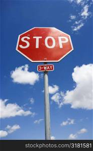 Stop sign with blue cloudy sky.