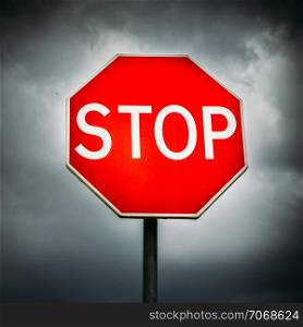 Stop sign with dark clouds