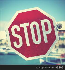 Stop traffic sign on the barrier. Retro style filtred image