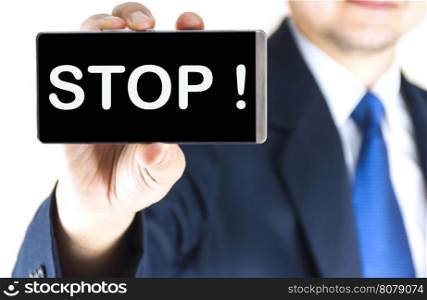 STOP !, word on mobile phone screen in blurred young businessman hand over white background, business concept