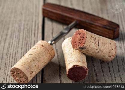 Stopper And Old Corkscrew on a wooden. Stopper And Old Corkscrew
