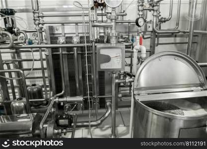 storage and pasteurization tank at the milk factory. equipment at the dairy plant. equipment at the milk factory