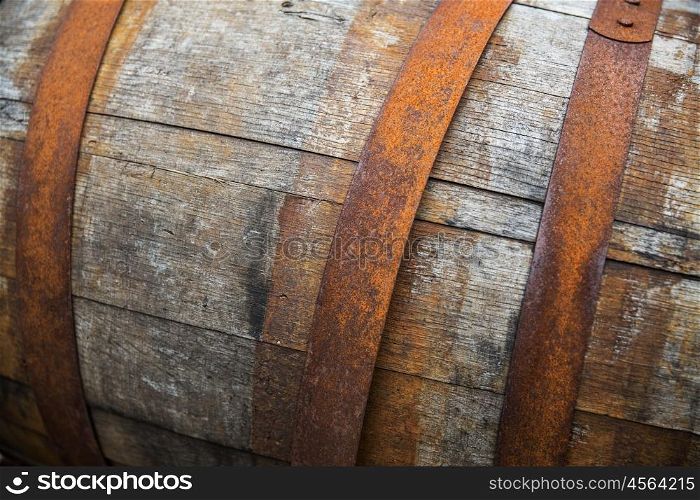 storage, container and object concept - close up of old wooden barrel with rusty hoops outdoors