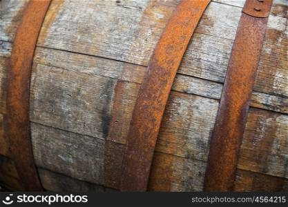storage, container and object concept - close up of old wooden barrel with rusty hoops outdoors