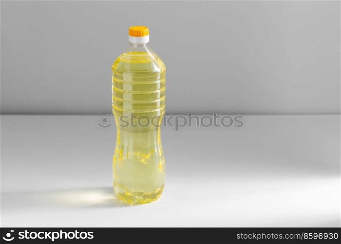 storage, food and culinary concept - close up of cooking rapeseed oil in plastic bottle on table. close up of cooking oil in plastic bottle on table