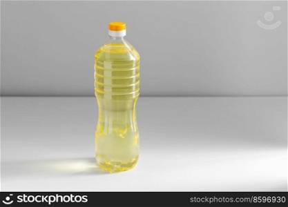 storage, food and culinary concept - close up of cooking rapeseed oil in plastic bottle on table. close up of cooking oil in plastic bottle on table