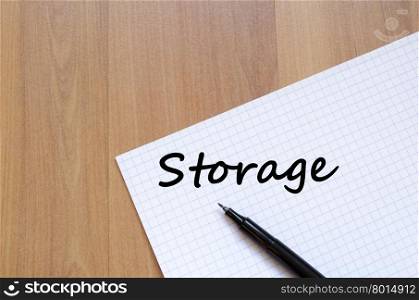 Storage text concept write on notebook with pen
