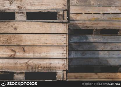 Storage wooden bins for the transportation of fruits and vegetables. Background of wooden crates. Warehouse with wooden crates close-up.