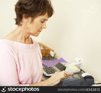 Store clerk types information into a credit card scanning machine.