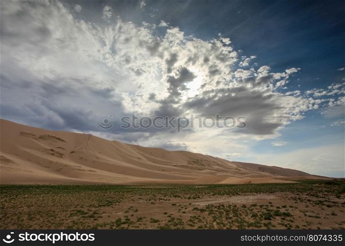 Storm clouds before rain in the Gobi Desert, dune Hongoryn, Mongolia.