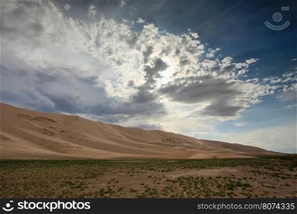 Storm clouds before rain in the Gobi Desert, dune Hongoryn, Mongolia.