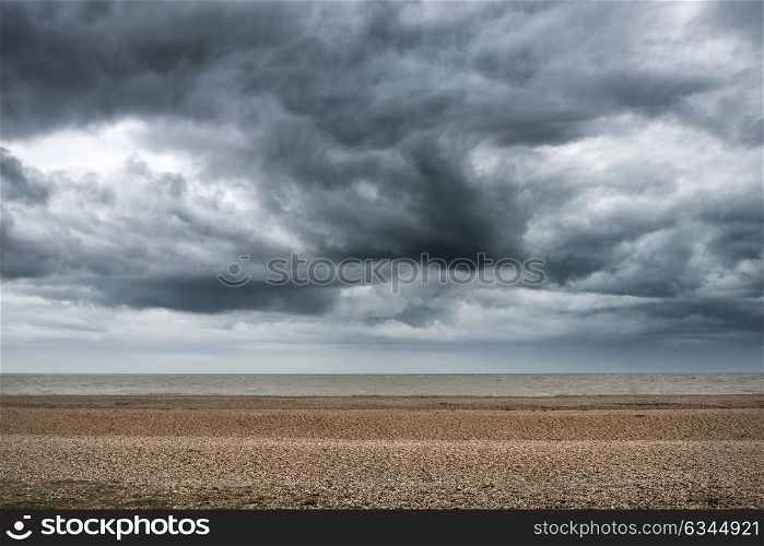 Storm clouds building over Winter beach landscape