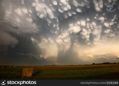 Storm Clouds Saskatchewan hay bales in Canada