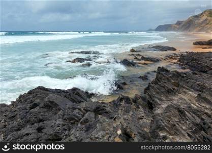 Storm on Castelejo beach with black schist cliffs (Algarve, Portugal).