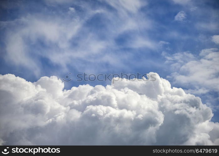 Stormy cumulus clouds with high level cirrocumulus clouds for use as background. Dramatic cumulus clouds with high level cirrocumulus clouds for