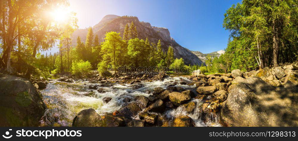 Stormy mountain river against sunshine sky panorama at Yosemite National Park, California USA