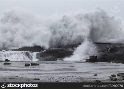 Stormy sea with waves crashing on rocks during Typhoon Souledor