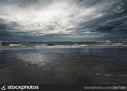 Stormy sky over sandy shore