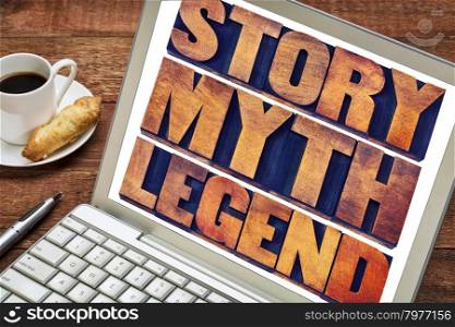 story, myth, legend word abstract - storytelling concept - collage of words in vintage letterpress wood type printing blocks on a laptop screen with a cup of coffee