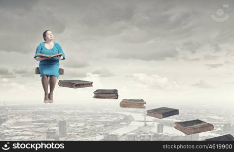 Stout woman. Plus size middle aged woman with book in hands