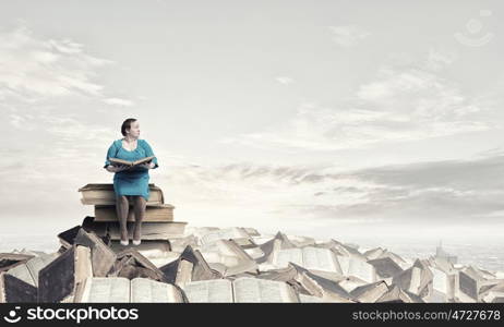 Stout woman. Plus size middle aged woman with book in hands