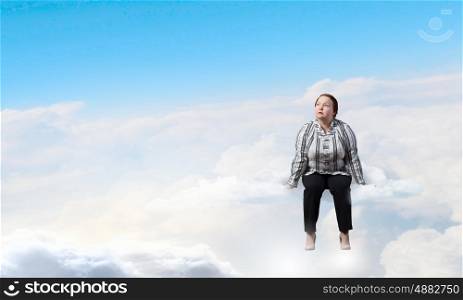 Stout woman. Plus size woman in casual sitting on cloud