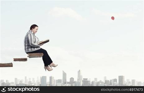 Stout woman. Plus size woman sitting with book in hands