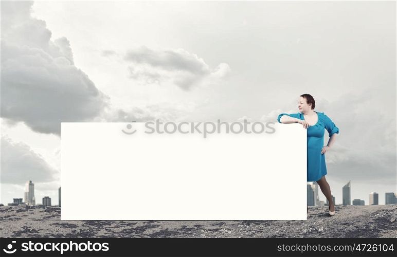 Stout woman with banner. Stout confident woman of middle age with blank white banner
