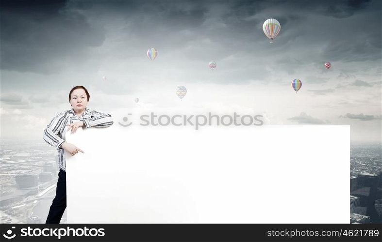 Stout woman with banner. Stout woman of middle age pointing at blank white banner