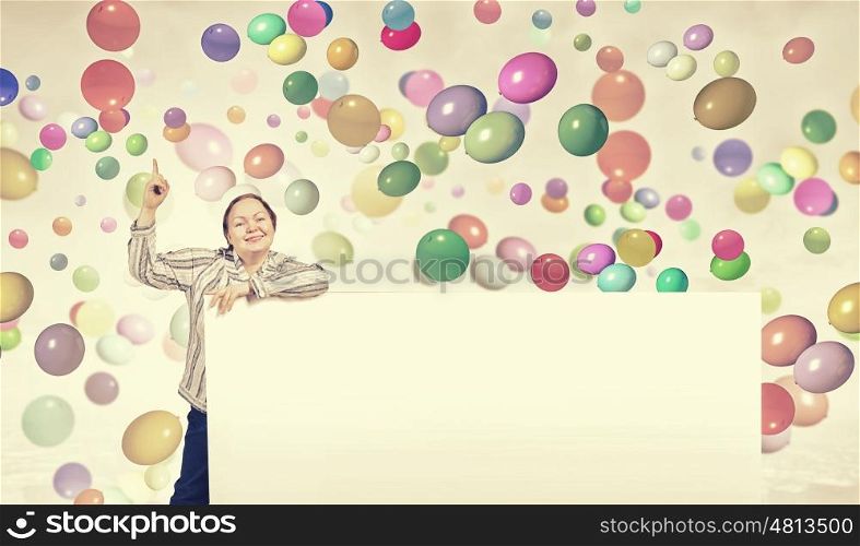 Stout woman with banner. Stout woman of middle age pointing at blank white banner