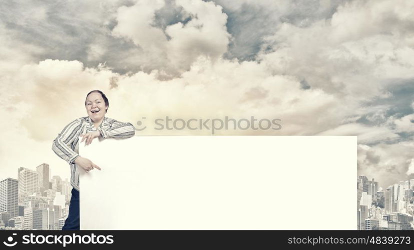 Stout woman with banner. Stout woman of middle age pointing at blank white banner