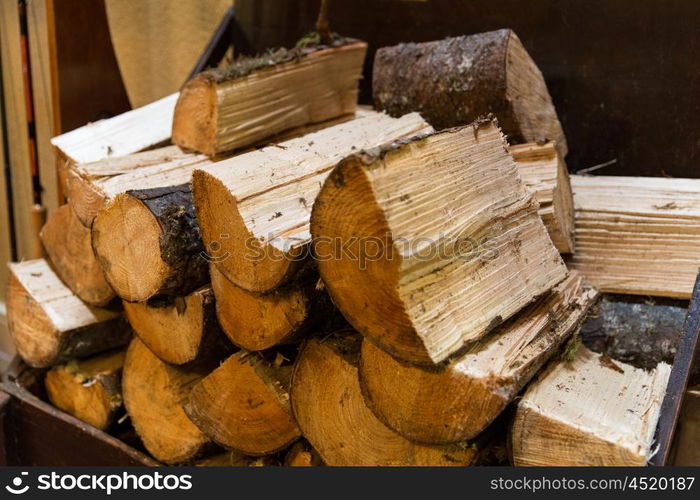 stove heating, fuel and wood concept - close up of firewood pile