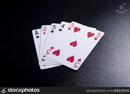 straight poker card on dark black background