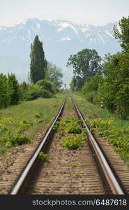 Straight railway and mountain in Brasov, Romania. Straight railway and mountain