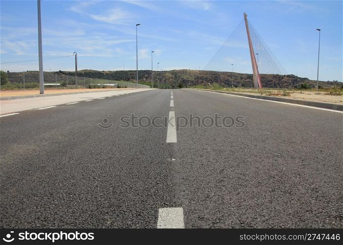 Straight tar road leading into