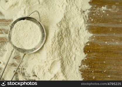 Strainer full of flour to sift it on the table