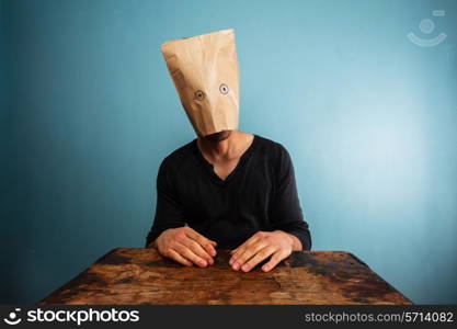 Strange man with a paper bag over his head