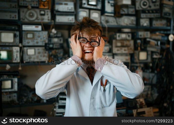 Strange scientist has gone mad in his laboratory. Electrical testing tools on background. Lab equipment. Strange scientist has gone mad in his laboratory