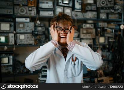 Strange scientist has gone mad in his laboratory. Electrical testing tools on background. Lab equipment. Strange scientist has gone mad in his laboratory
