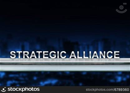 strategic alliance on metal railing with blurred background